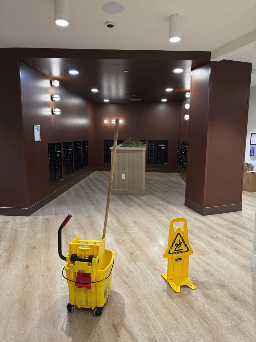 Building lobby being mopped with wet floor signs in place